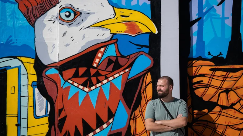Dani Treble in front of a mural